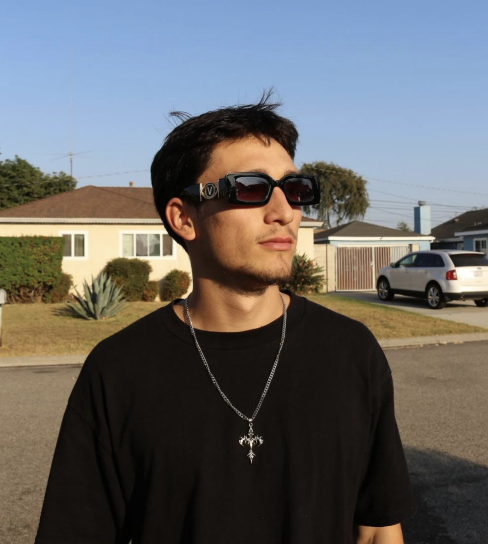 shelfz posing in a neighborhood with dark rimmed glasses